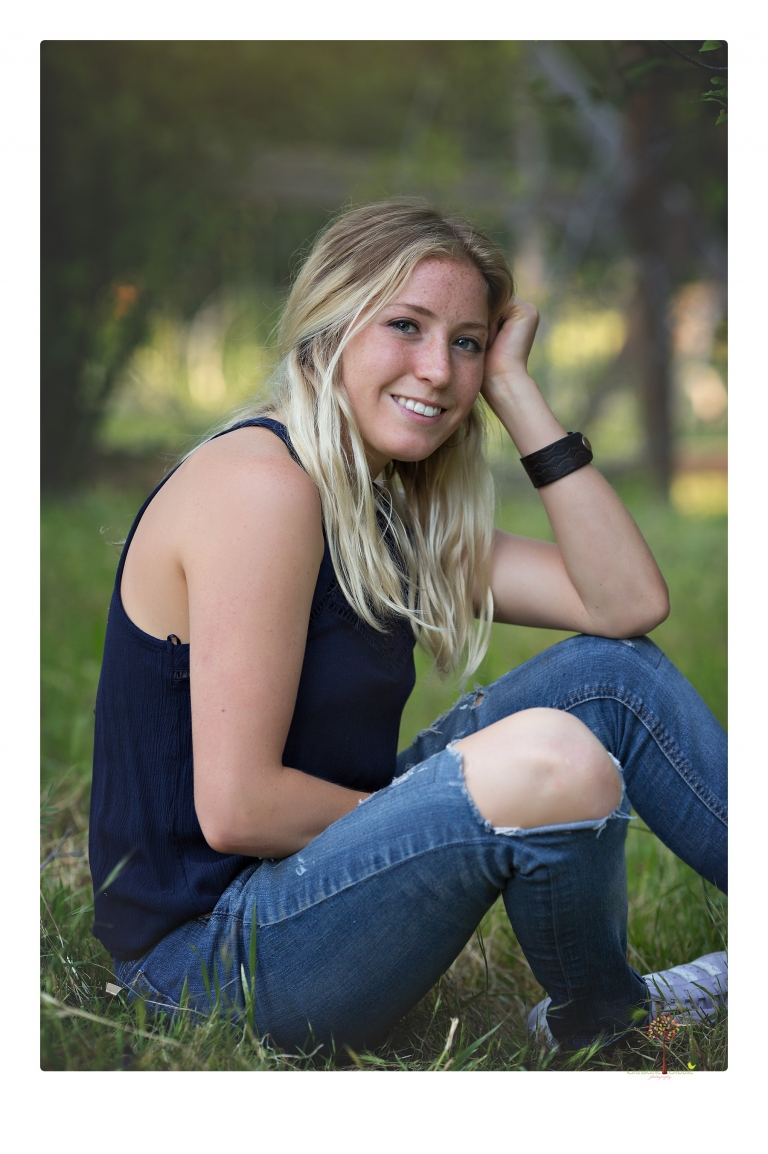 Sonora senior portrait photographer Christine Dibble Photography photographs a Sonora water polo graduate in her yard.