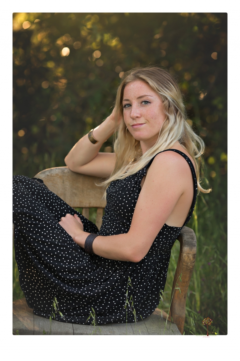 Sonora senior portrait photographer Christine Dibble Photography photographs a Sonora water polo graduate in her yard.