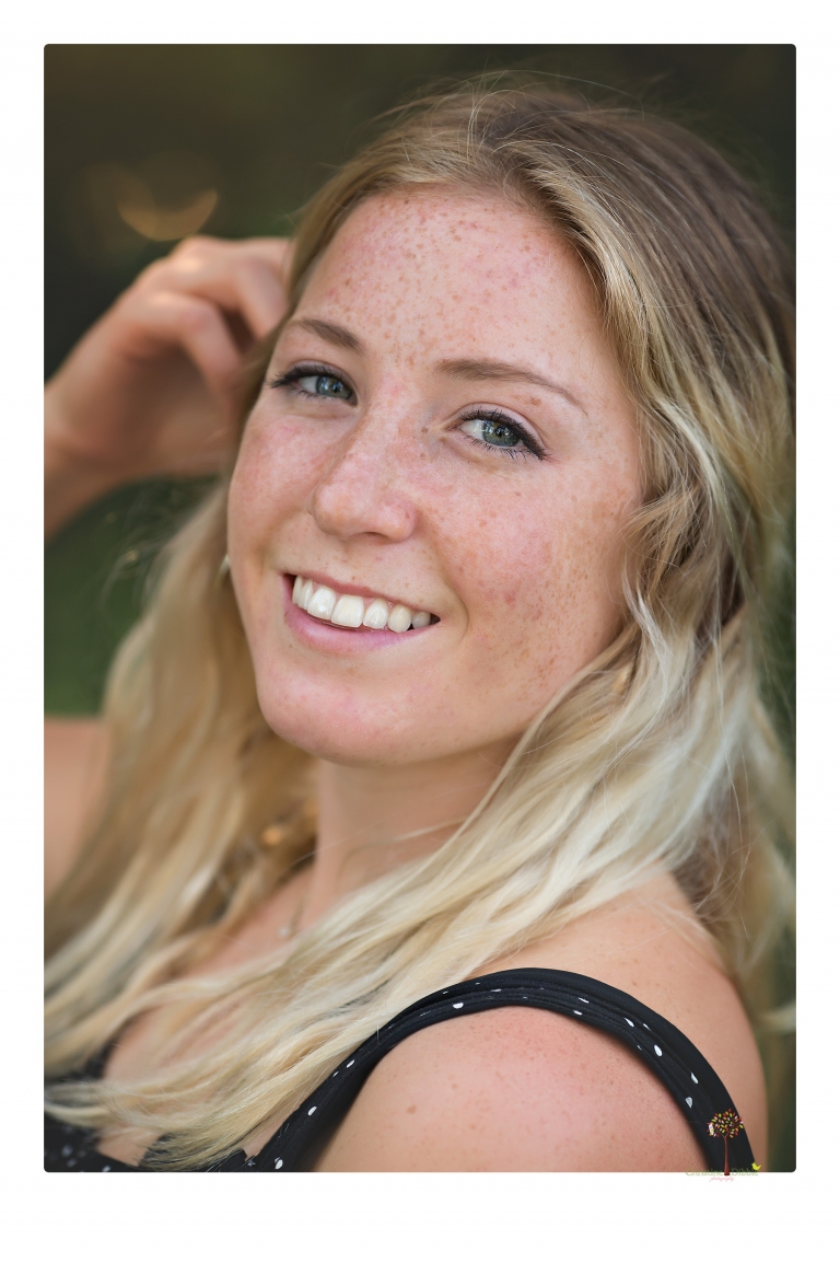 Sonora senior portrait photographer Christine Dibble Photography photographs a Sonora water polo graduate in her yard.