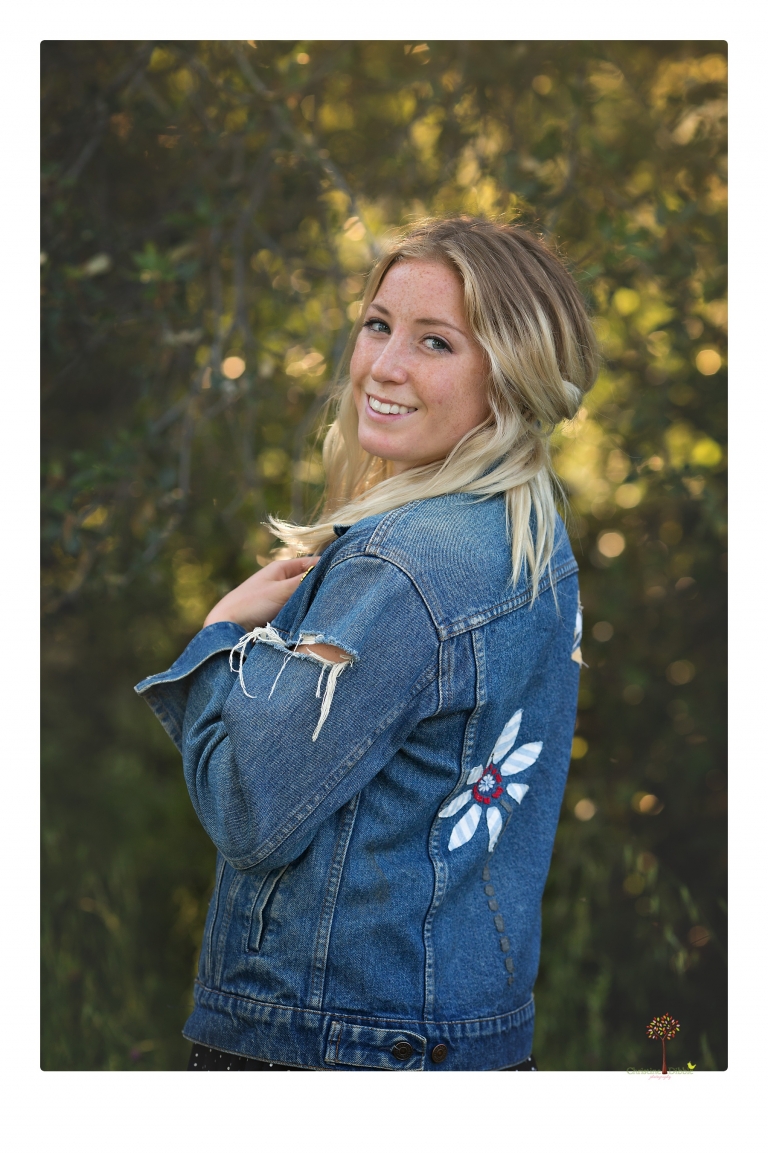 Sonora senior portrait photographer Christine Dibble Photography photographs a Sonora water polo graduate in her yard.