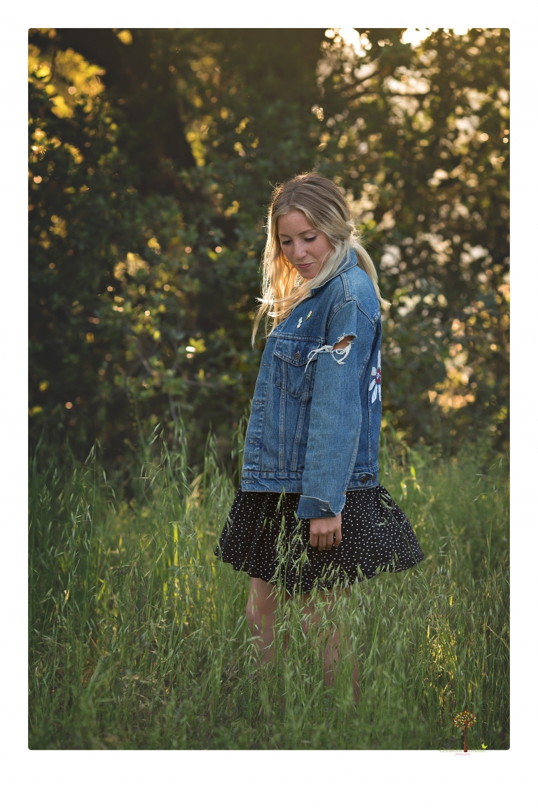 Sonora senior portrait photographer Christine Dibble Photography photographs a Sonora water polo graduate in her yard.