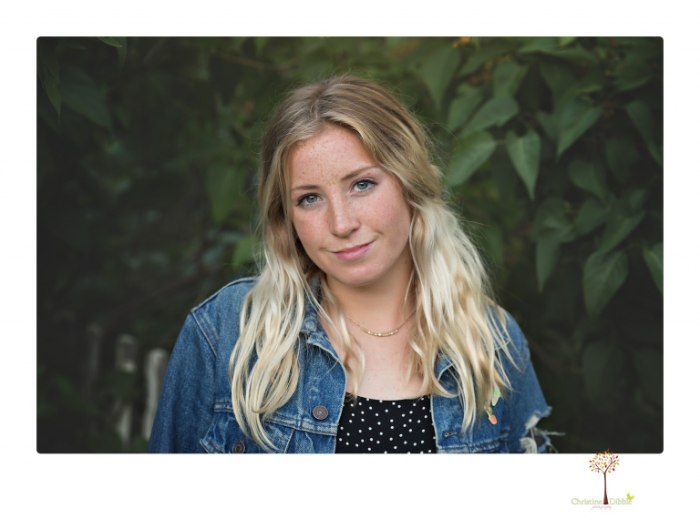 Sonora senior portrait photographer Christine Dibble Photography photographs a Sonora water polo graduate in her yard.