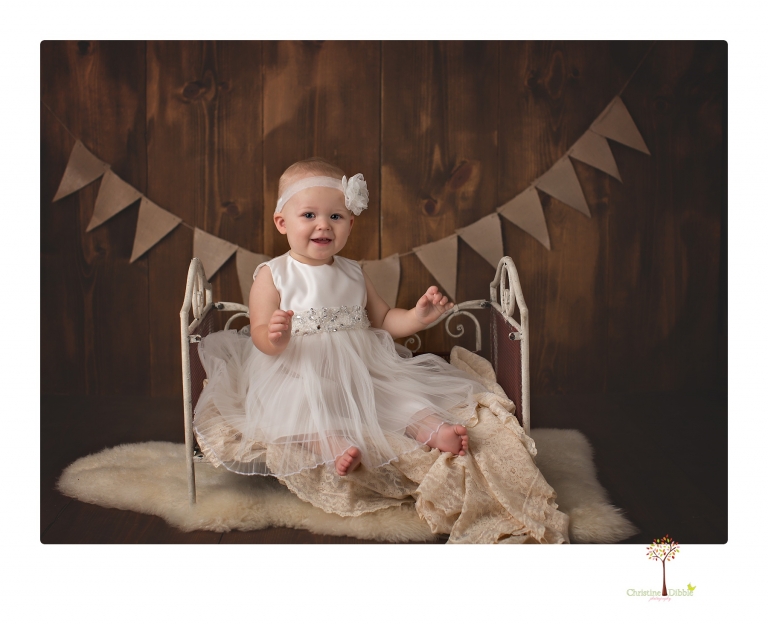 Sonora Baby Photographer Christine Dibble Photography photographs a first birthday session of a girl wearing a flower girl dress made from her mother's wedding dress.