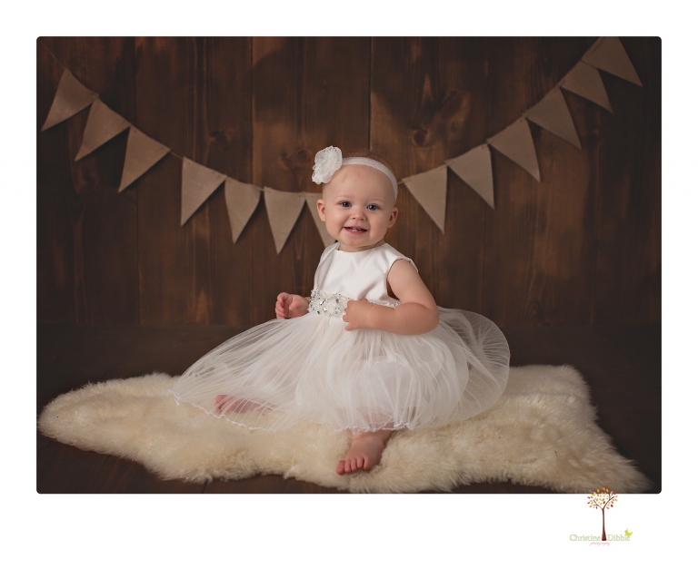 Sonora Baby Photographer Christine Dibble Photography photographs a first birthday session of a girl wearing a flower girl dress made from her mother's wedding dress.