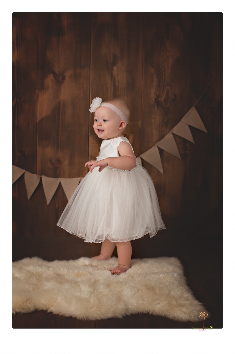 Sonora Baby Photographer Christine Dibble Photography photographs a first birthday session of a girl wearing a flower girl dress made from her mother's wedding dress.