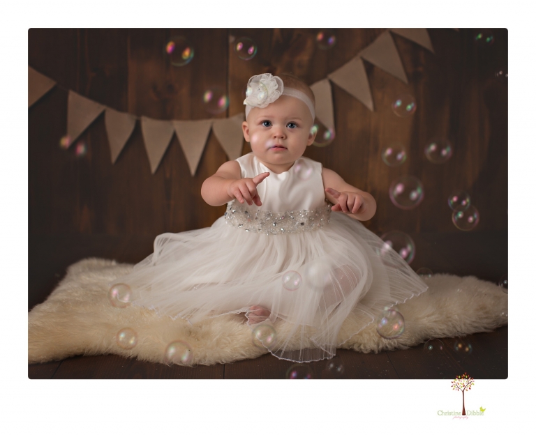 Sonora Baby Photographer Christine Dibble Photography photographs a first birthday session of a girl wearing a flower girl dress made from her mother's wedding dress.