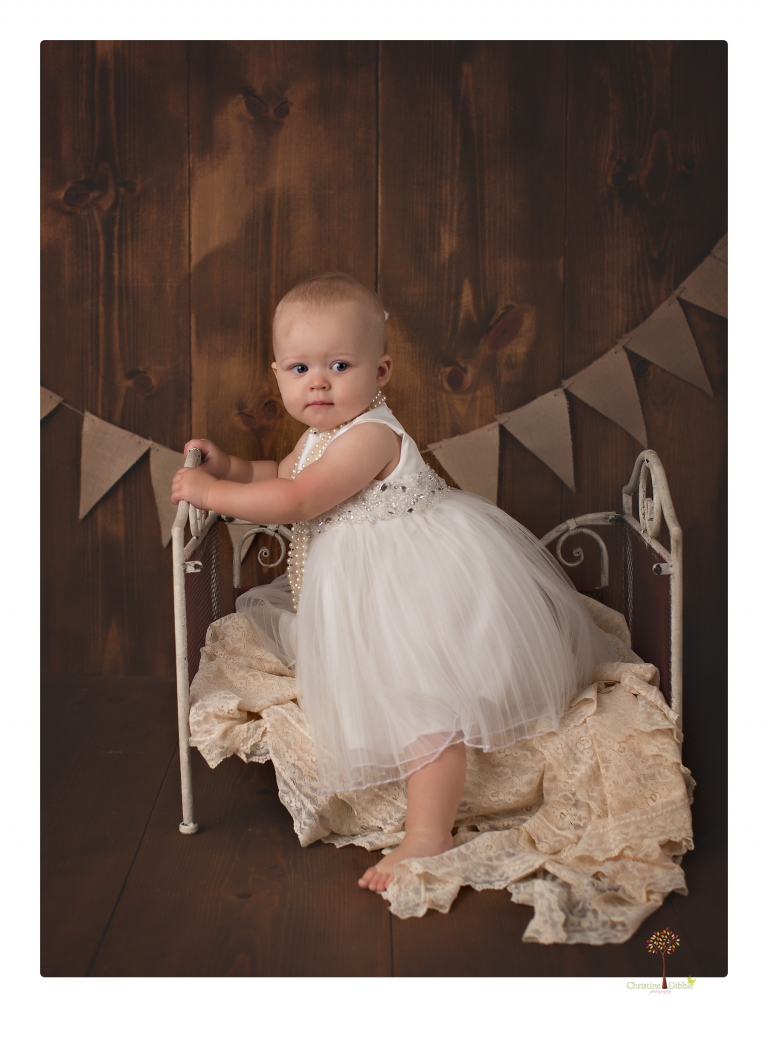 Sonora Baby Photographer Christine Dibble Photography photographs a first birthday session of a girl wearing a flower girl dress made from her mother's wedding dress.