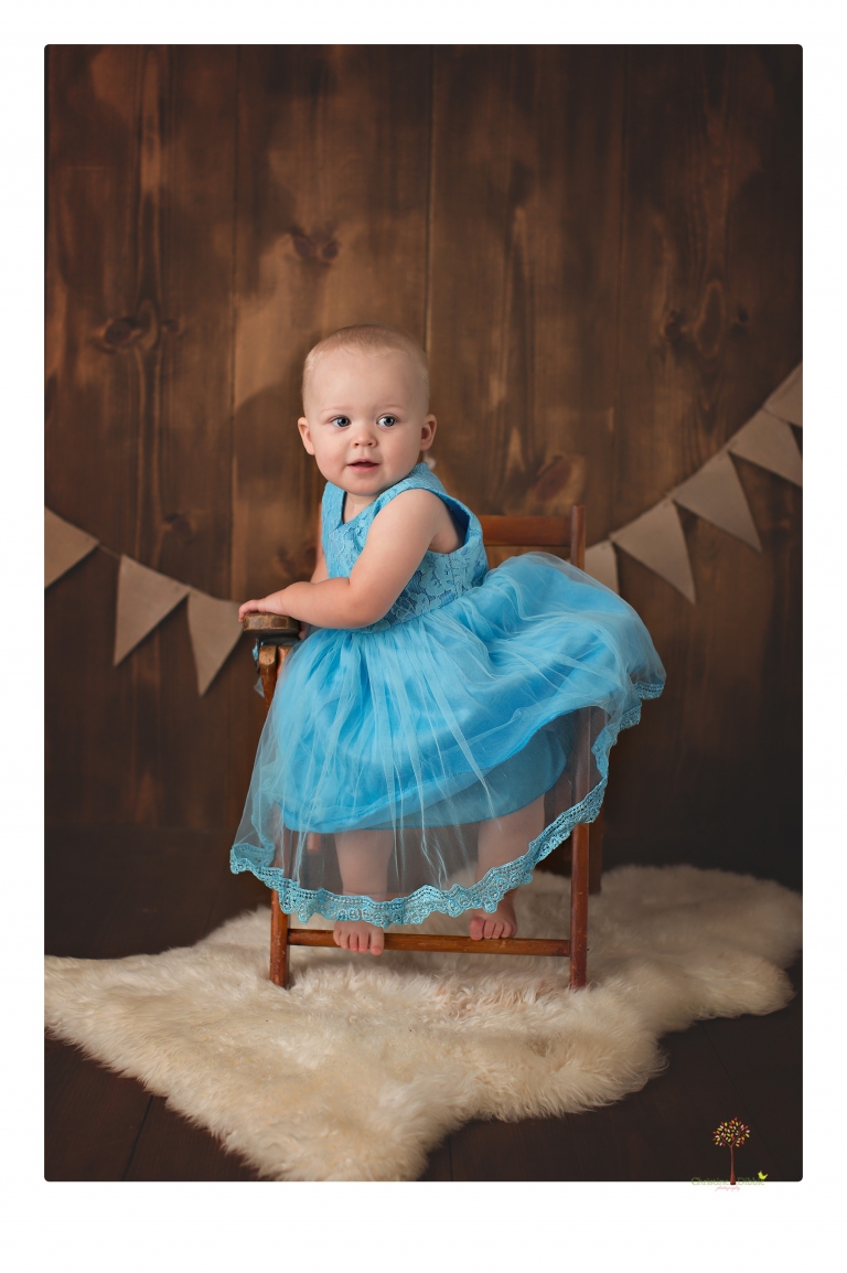 Sonora Baby Photographer Christine Dibble Photography photographs a first birthday session of a girl wearing a flower girl dress made from her mother's wedding dress.
