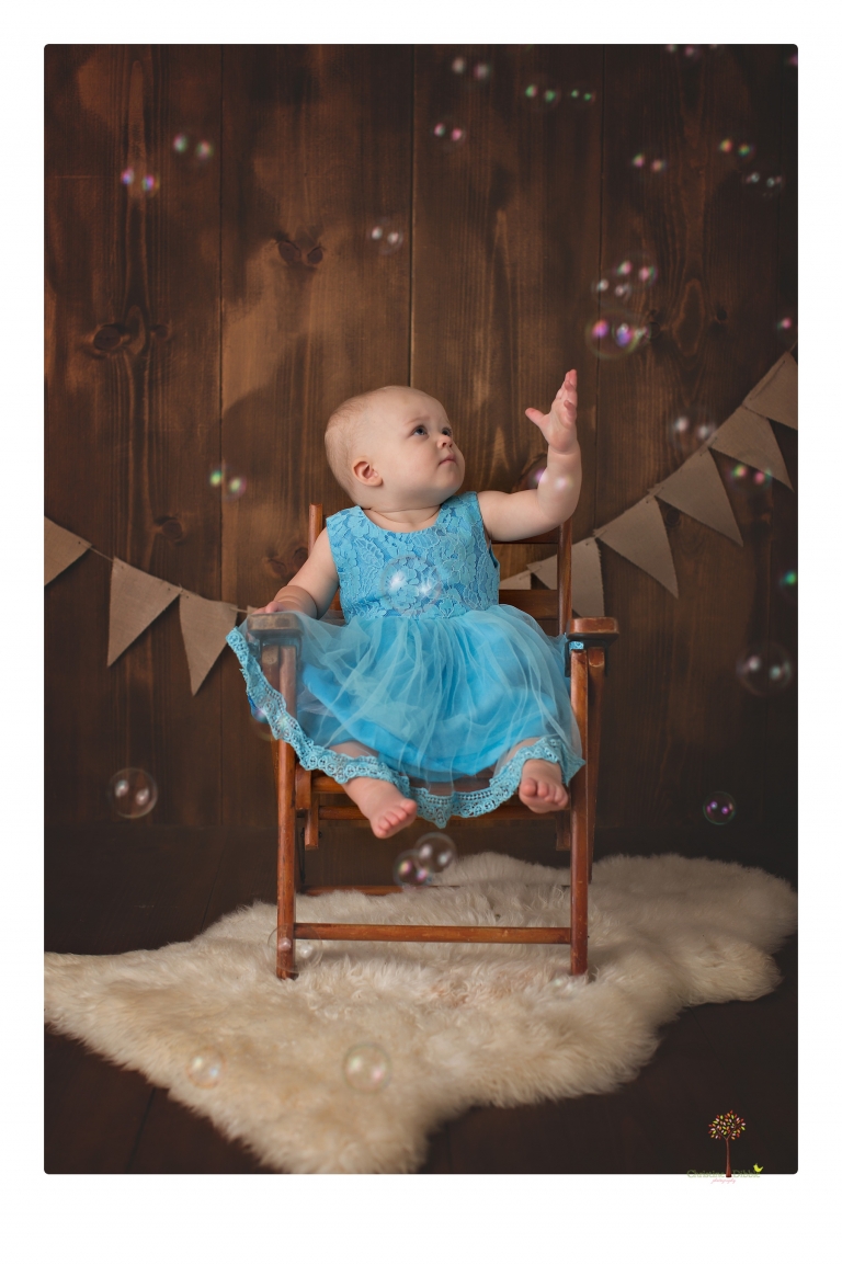 Sonora Baby Photographer Christine Dibble Photography photographs a first birthday session of a girl wearing a flower girl dress made from her mother's wedding dress.