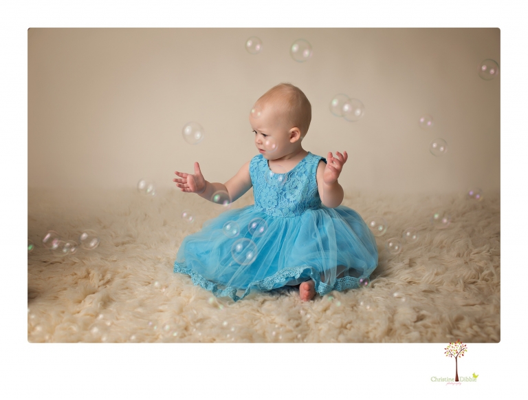 Sonora Baby Photographer Christine Dibble Photography photographs a first birthday session of a girl wearing a flower girl dress made from her mother's wedding dress.