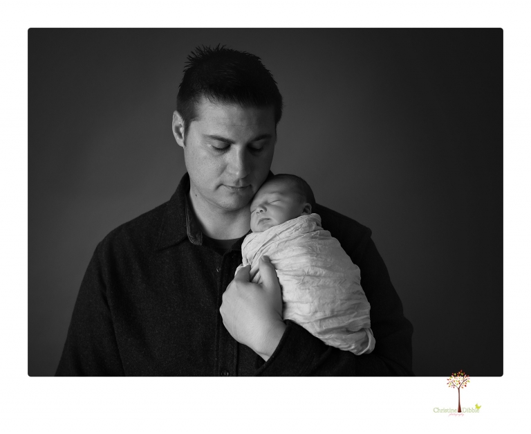 Sonora Newborn Photographer Christine Dibble Photography takes newborn portraits of a baby in a ski boot and with his parents.