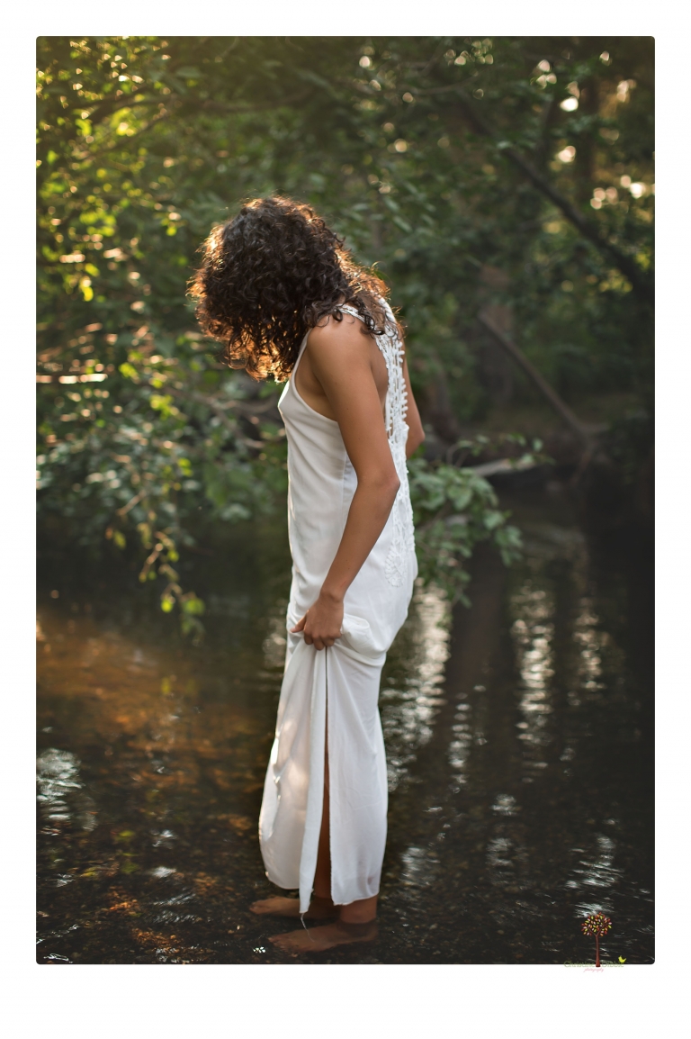 Sonora photographer Christine Dibble Photography takes portraits of a senior in Mammoth Lakes as she poses in a creek and meadow in thrift shop dresses.