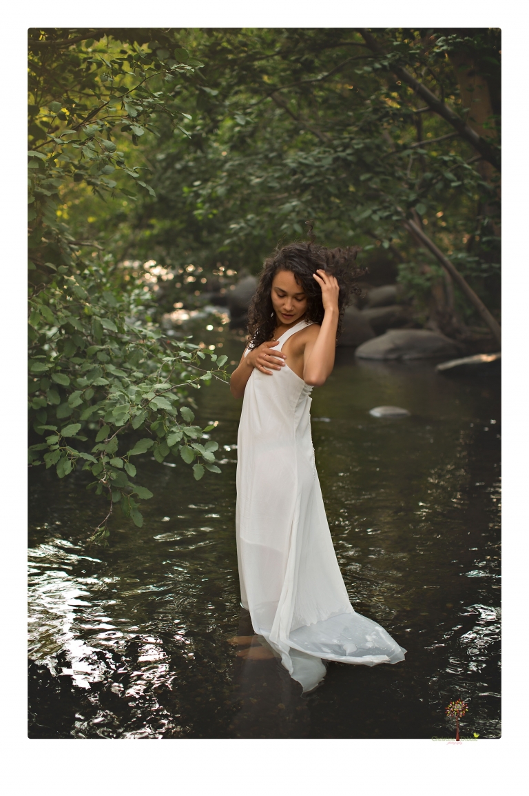 Sonora photographer Christine Dibble Photography takes portraits of a senior in Mammoth Lakes as she poses in a creek and meadow in thrift shop dresses.