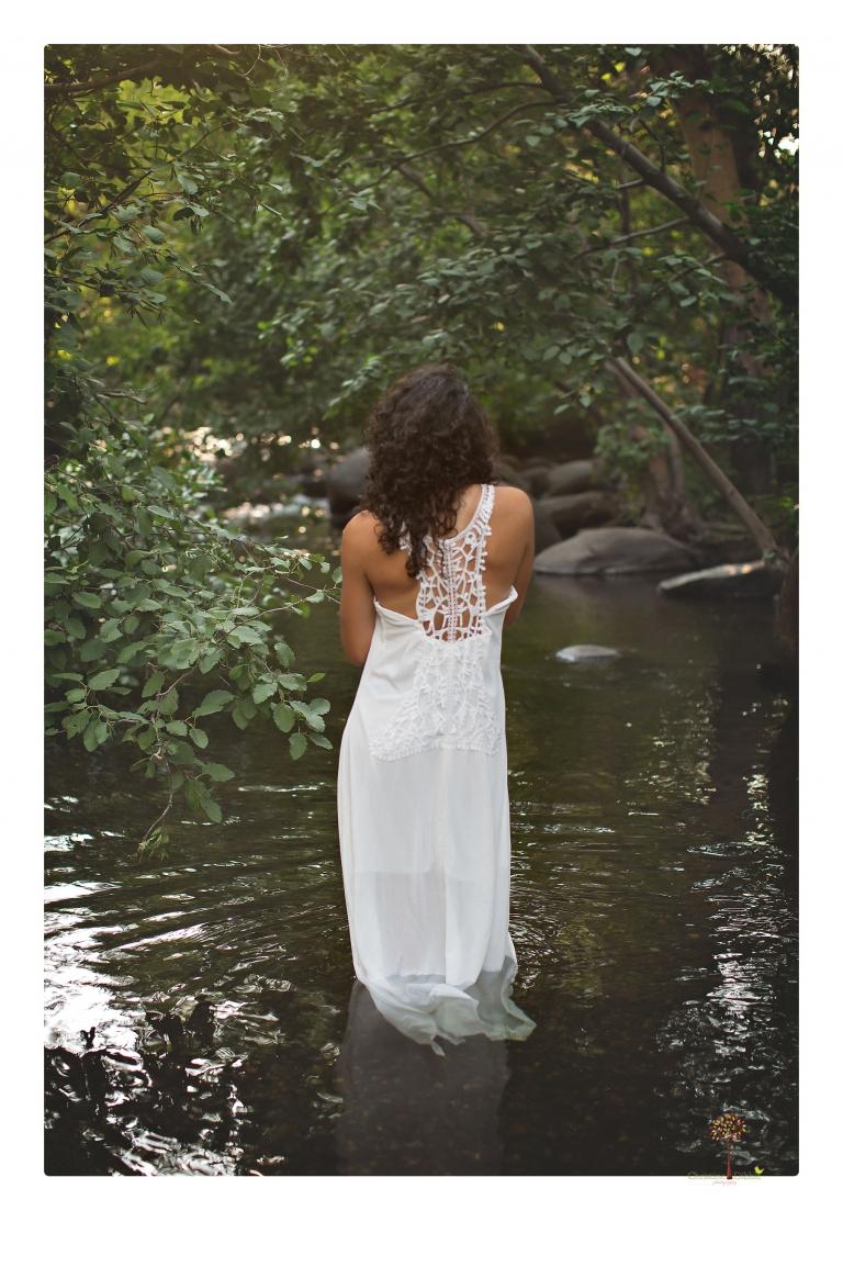 Sonora photographer Christine Dibble Photography takes portraits of a senior in Mammoth Lakes as she poses in a creek and meadow in thrift shop dresses.