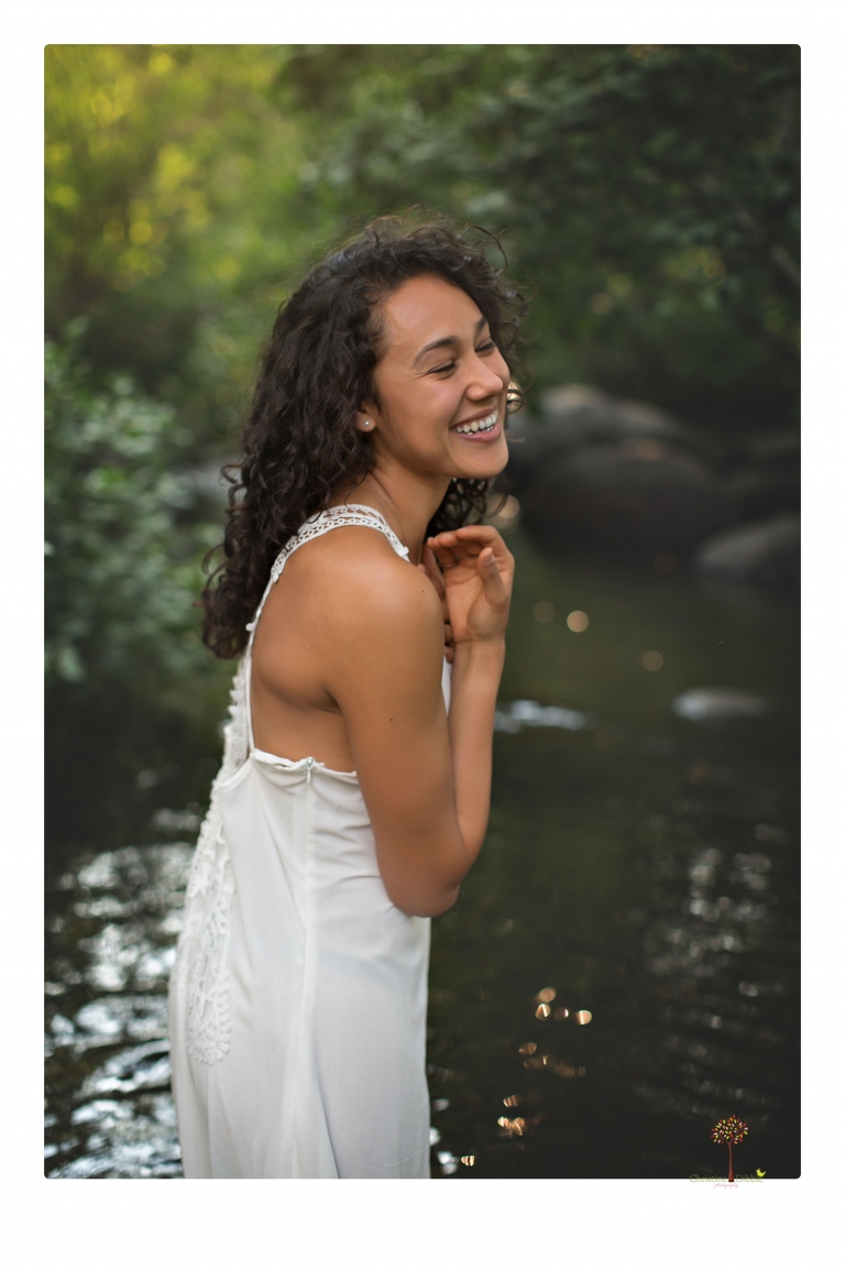 Sonora photographer Christine Dibble Photography takes portraits of a senior in Mammoth Lakes as she poses in a creek and meadow in thrift shop dresses.