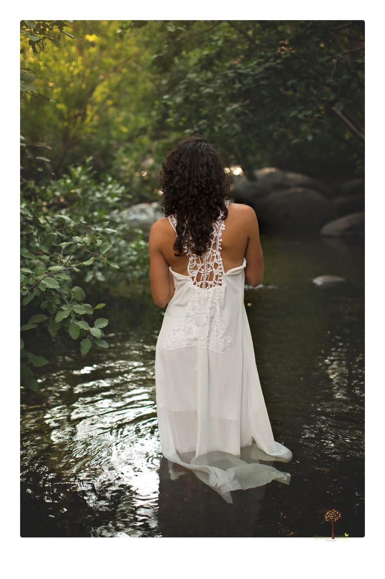 Sonora photographer Christine Dibble Photography takes portraits of a senior in Mammoth Lakes as she poses in a creek and meadow in thrift shop dresses.