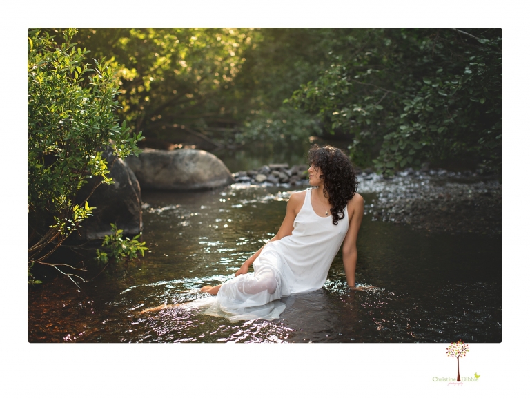 Sonora photographer Christine Dibble Photography takes portraits of a senior in Mammoth Lakes as she poses in a creek and meadow in thrift shop dresses.
