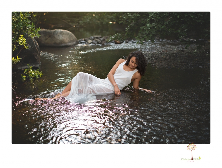 Sonora photographer Christine Dibble Photography takes portraits of a senior in Mammoth Lakes as she poses in a creek and meadow in thrift shop dresses.