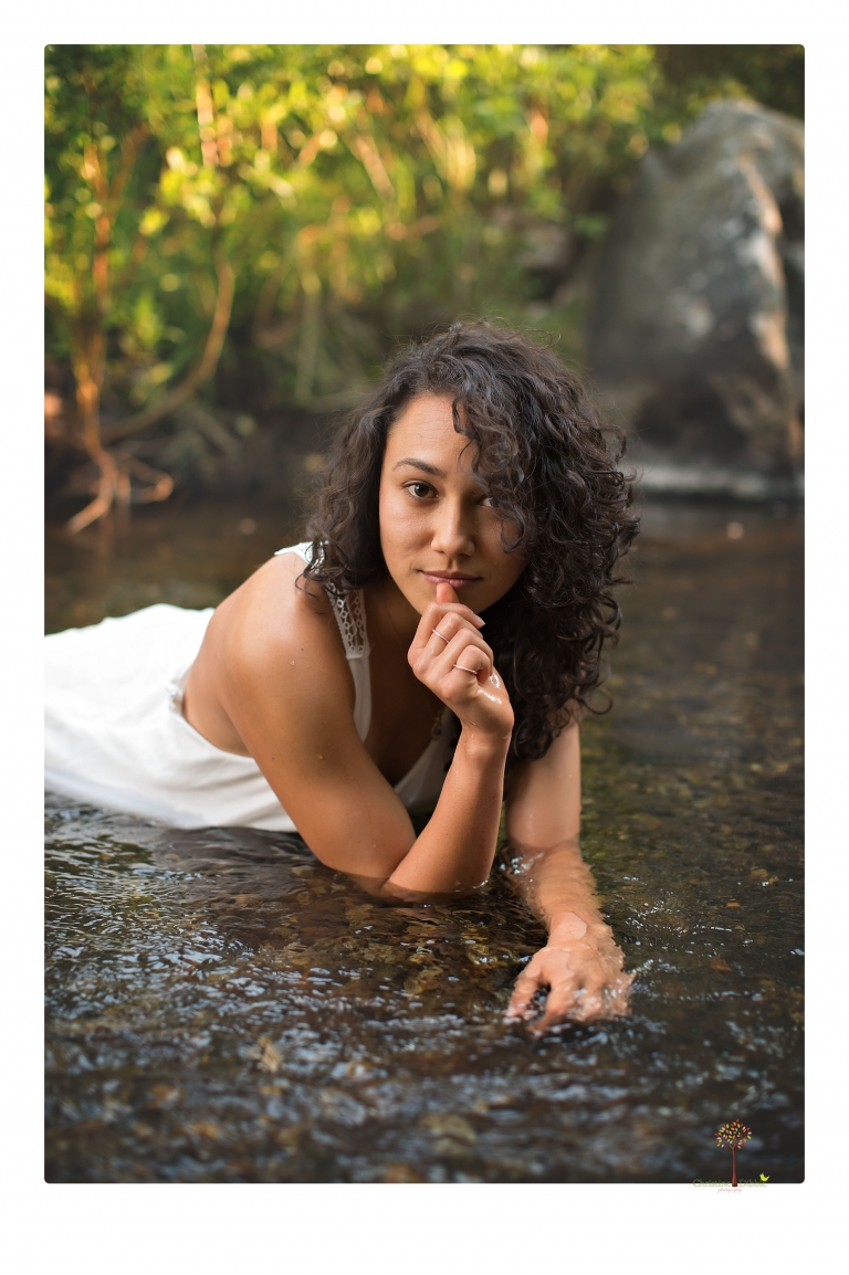 Sonora photographer Christine Dibble Photography takes portraits of a senior in Mammoth Lakes as she poses in a creek and meadow in thrift shop dresses.