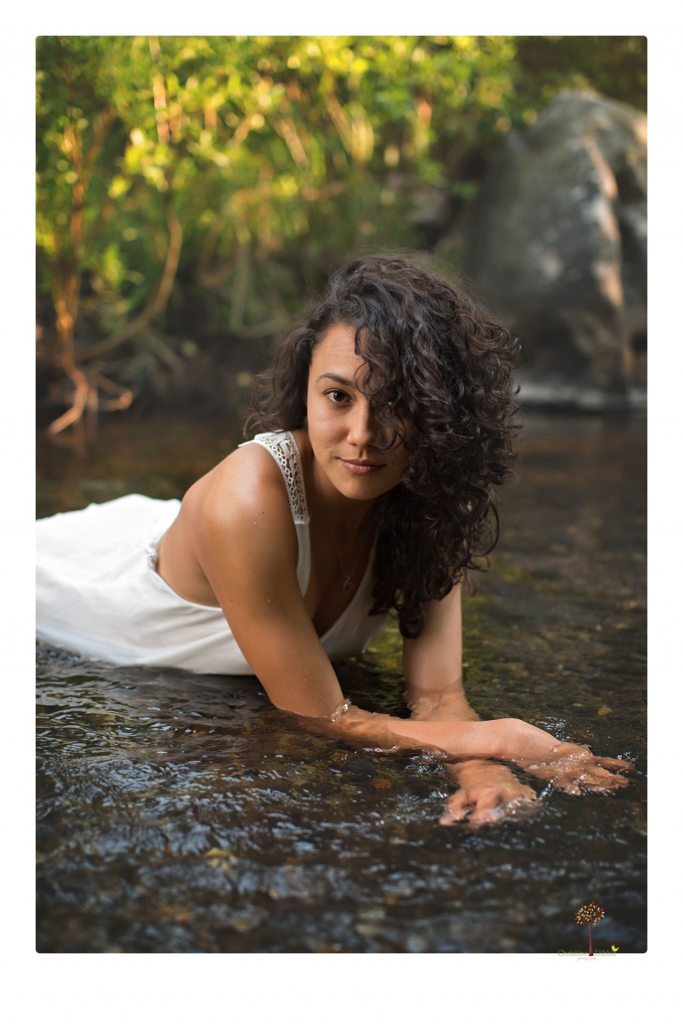 Sonora photographer Christine Dibble Photography takes portraits of a senior in Mammoth Lakes as she poses in a creek and meadow in thrift shop dresses.