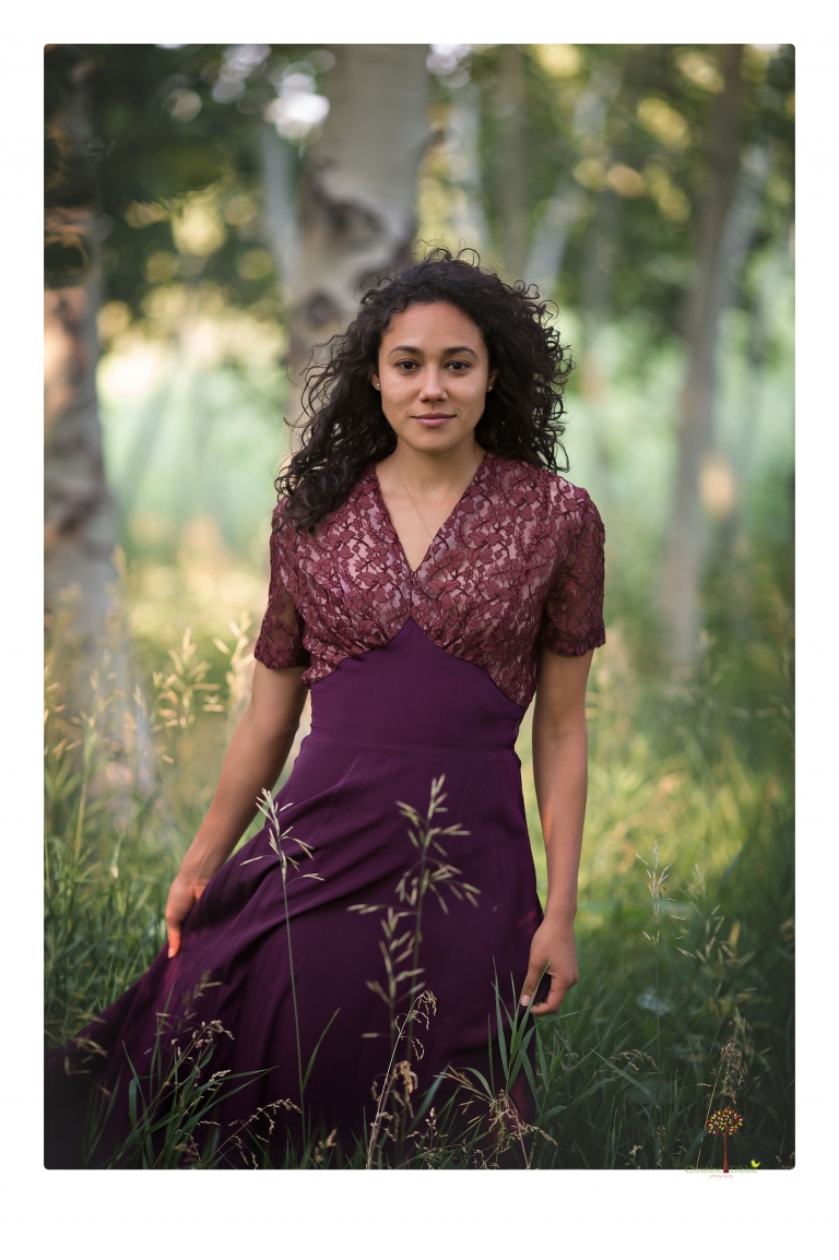Sonora photographer Christine Dibble Photography takes portraits of a senior in Mammoth Lakes as she poses in a creek and meadow in thrift shop dresses.