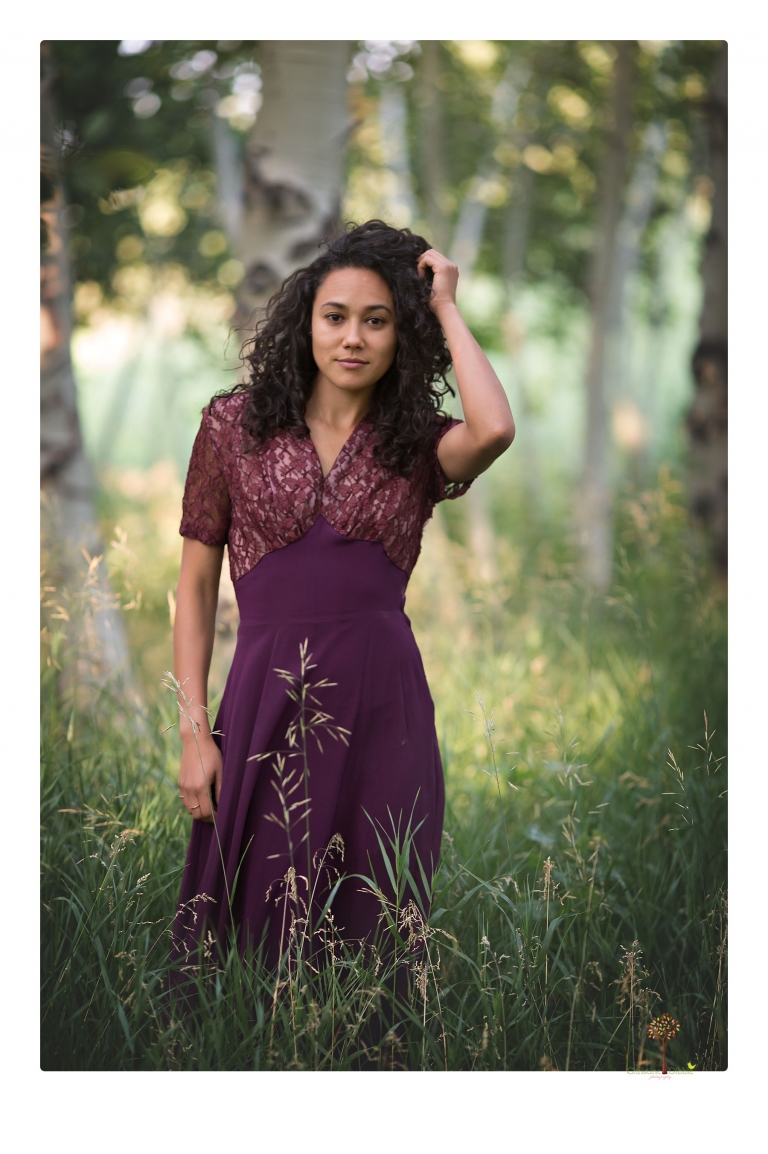 Sonora photographer Christine Dibble Photography takes portraits of a senior in Mammoth Lakes as she poses in a creek and meadow in thrift shop dresses.