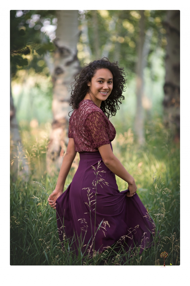 Sonora photographer Christine Dibble Photography takes portraits of a senior in Mammoth Lakes as she poses in a creek and meadow in thrift shop dresses.