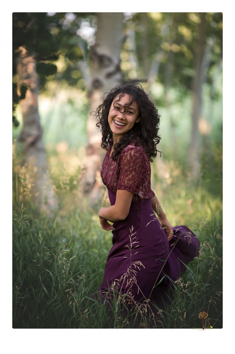 Sonora photographer Christine Dibble Photography takes portraits of a senior in Mammoth Lakes as she poses in a creek and meadow in thrift shop dresses.