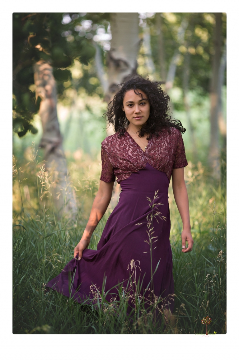 Sonora photographer Christine Dibble Photography takes portraits of a senior in Mammoth Lakes as she poses in a creek and meadow in thrift shop dresses.