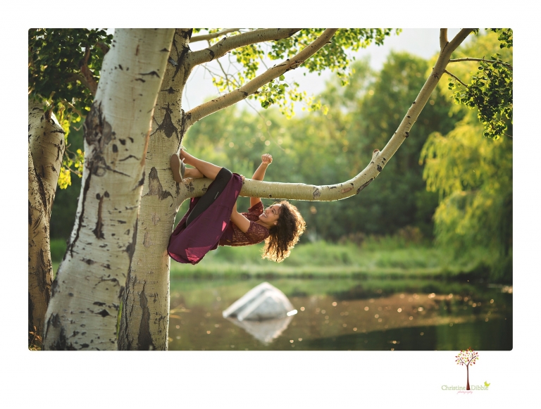 Sonora photographer Christine Dibble Photography takes portraits of a senior in Mammoth Lakes as she poses in a creek and meadow in thrift shop dresses.