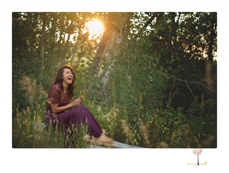 Sonora photographer Christine Dibble Photography takes portraits of a senior in Mammoth Lakes as she poses in a creek and meadow in thrift shop dresses.
