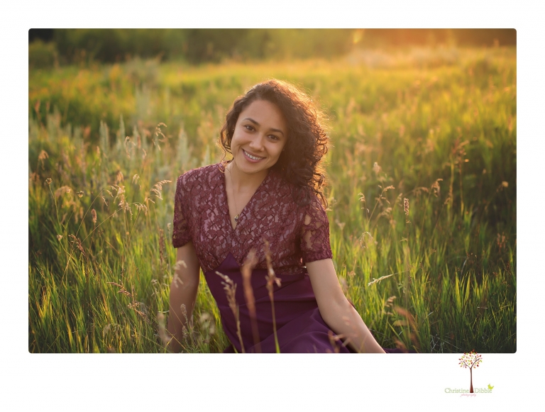 Sonora photographer Christine Dibble Photography takes portraits of a senior in Mammoth Lakes as she poses in a creek and meadow in thrift shop dresses.