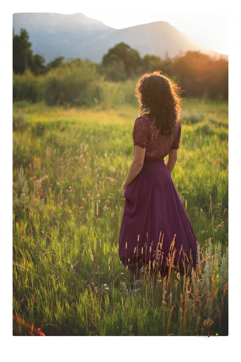 Sonora photographer Christine Dibble Photography takes portraits of a senior in Mammoth Lakes as she poses in a creek and meadow in thrift shop dresses.